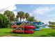 Colorful kayaks on a rack near the water, with palm trees and a blue sky in the background at 5282 Beach Se Dr # D, St Petersburg, FL 33705