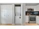 Convenient laundry closet with stacked washer and dryer adjacent to kitchen area at 5282 Beach Se Dr # D, St Petersburg, FL 33705