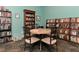 Cozy library room featuring a round table with chairs surrounded by bookshelves filled with books at 5282 Beach Se Dr # D, St Petersburg, FL 33705