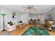 Bright living room with cozy seating, ceiling fan, and stylish decor at 5282 Beach Se Dr # D, St Petersburg, FL 33705