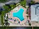 Aerial view of community pool area with lounge chairs and lush landscaping at 5282 Beach Se Dr # D, St Petersburg, FL 33705