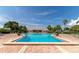 Inviting outdoor pool surrounded by a brick deck, lounge chairs and tropical landscaping under a bright sky at 5282 Beach Se Dr # D, St Petersburg, FL 33705