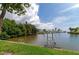 Water access with a ladder, lush greenery, and a peaceful view of the waterfront community at 5282 Beach Se Dr # D, St Petersburg, FL 33705