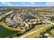 Aerial view of a luxury community with lake, homes, and lush landscaping at 5639 Rain Lily Ct, Sarasota, FL 34238