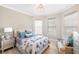 Bright bedroom with a queen-size bed and large windows at 5639 Rain Lily Ct, Sarasota, FL 34238