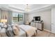 Bright bedroom with comfy bed and en-suite TV at 5639 Rain Lily Ct, Sarasota, FL 34238