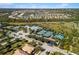 Aerial view of community amenities including tennis courts and pool at 5639 Rain Lily Ct, Sarasota, FL 34238