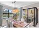 Bright dining room, sliders open to outdoor kitchen and pool at 5639 Rain Lily Ct, Sarasota, FL 34238
