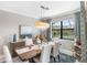 Elegant dining room with wooden table and pool view at 5639 Rain Lily Ct, Sarasota, FL 34238