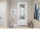 Bright entryway with white door and decorative accents at 5639 Rain Lily Ct, Sarasota, FL 34238