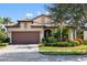 Single-story home with brown garage door and landscaped yard at 5639 Rain Lily Ct, Sarasota, FL 34238