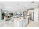 Open kitchen with island, stainless steel appliances, living room view at 5639 Rain Lily Ct, Sarasota, FL 34238