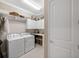 Laundry room with washer, dryer, and ample storage at 5639 Rain Lily Ct, Sarasota, FL 34238