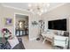 Home office with modern decor and large TV at 5639 Rain Lily Ct, Sarasota, FL 34238