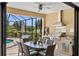 Outdoor kitchen with stainless steel grill and dining area at 5639 Rain Lily Ct, Sarasota, FL 34238