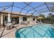 Inviting pool area with patio furniture and a screened enclosure at 5639 Rain Lily Ct, Sarasota, FL 34238