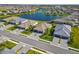 Aerial view of lakefront homes with tile roofs and two-car garages at 5429 Mystic Water Cv, Bradenton, FL 34211