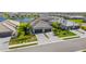 Aerial view of new homes with tile roofs and two-car garages, located near a lake at 5429 Mystic Water Cv, Bradenton, FL 34211