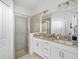 Double vanity bathroom with a walk-in shower at 5429 Mystic Water Cv, Bradenton, FL 34211