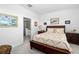 Main bedroom with a king-size bed and ensuite bathroom at 5429 Mystic Water Cv, Bradenton, FL 34211