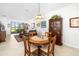 Charming dining room with wood table and view to living room at 5429 Mystic Water Cv, Bradenton, FL 34211