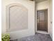 Front door entry with decorative arch and paver walkway at 5429 Mystic Water Cv, Bradenton, FL 34211