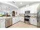 Modern kitchen featuring stainless steel appliances and granite countertops at 5429 Mystic Water Cv, Bradenton, FL 34211