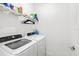 Convenient laundry room with washer, dryer, and shelving at 5429 Mystic Water Cv, Bradenton, FL 34211