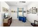 Bright office space with a blue desk and window at 5429 Mystic Water Cv, Bradenton, FL 34211