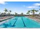 Community lap pool with plenty of lounge chairs at 5429 Mystic Water Cv, Bradenton, FL 34211