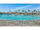 Freeform pool with surrounding lounge chairs at 5429 Mystic Water Cv, Bradenton, FL 34211