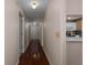 Hallway with hardwood floors leading to the front door and kitchen at 5441 18Th W Ct, Bradenton, FL 34207