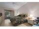 Cozy bedroom with a queen bed, ceiling fan, and sliding glass doors leading to the outdoor space at 5441 18Th W Ct, Bradenton, FL 34207