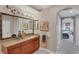 Bathroom featuring granite countertops, a vanity, and a large decorative mirror at 5531 Cannes Cir # 605, Sarasota, FL 34231