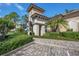 Exterior shot of a clubhouse with a tile roof and manicured landscaping, showcasing the building's architectural details at 5531 Cannes Cir # 605, Sarasota, FL 34231