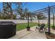Relaxing backyard patio featuring a pergola, a grill, and beautiful landscaping with lush green grass at 5809 71St E St, Palmetto, FL 34221