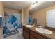 Bathroom featuring a double sink vanity and a shower with a turtle-themed curtain at 5809 71St E St, Palmetto, FL 34221