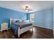 Charming bedroom featuring a ceiling fan, wood floors, and light blue walls at 5809 71St E St, Palmetto, FL 34221