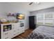 Bedroom features gray and white decor with a dark dresser, large window, and patterned bedding at 5809 71St E St, Palmetto, FL 34221