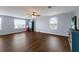 Spacious bonus room with dark wood floors, large windows, a ceiling fan, and neutral walls at 5809 71St E St, Palmetto, FL 34221