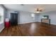 Large bonus room with a ceiling fan, dark wood floors, and plenty of natural light from the big windows at 5809 71St E St, Palmetto, FL 34221