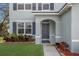 Inviting entrance with a beautifully landscaped garden and a gray-painted door at 5809 71St E St, Palmetto, FL 34221