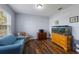 Cozy home office features a large window, wood-look floors, a comfortable blue sofa, and an aquarium at 5809 71St E St, Palmetto, FL 34221