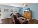 Cozy living room with leather reclining sofa and chair, a ceiling fan and a large window with blinds at 5809 71St E St, Palmetto, FL 34221