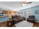 Comfortable living room with brown leather reclining furniture and a view into a dining area with wood paneling at 5809 71St E St, Palmetto, FL 34221