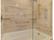 Bathroom features travertine shower and tub at 6517 Approach Rd # 57, Sarasota, FL 34238