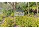 Westwoods, an Over 55 Community sign surrounded by lush landscaping at 6517 Approach Rd # 57, Sarasota, FL 34238