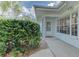 Inviting front entrance with a well-kept garden and a cozy covered porch at 6517 Approach Rd # 57, Sarasota, FL 34238