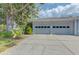 Spacious two-car garage with modern doors and a clean concrete driveway at 6517 Approach Rd # 57, Sarasota, FL 34238