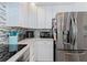 Close-up of stainless steel refrigerator and countertops in the kitchen at 6517 Approach Rd # 57, Sarasota, FL 34238